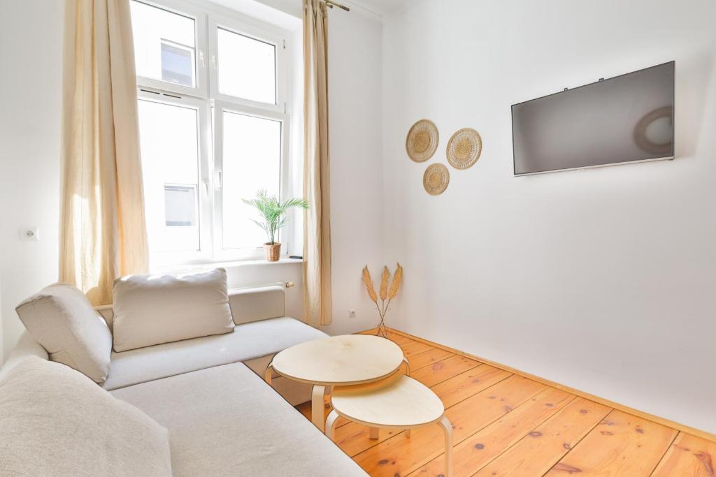 a living room with a white couch and a table at Sopot City Centre, Apartment 774 in Sopot