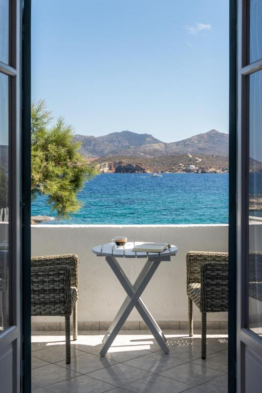 a table on a balcony with a view of the ocean at ILIAS SEA VIEW in Pollonia