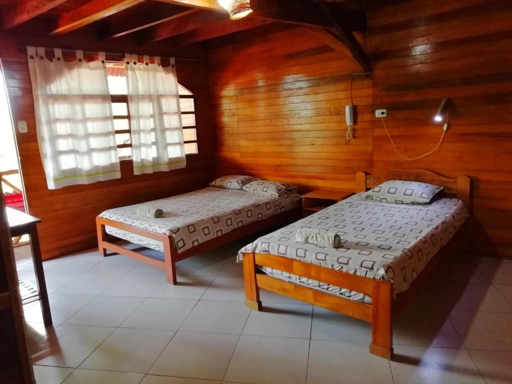 Postel nebo postele na pokoji v ubytování Madera Labrada Lodge Ecologico