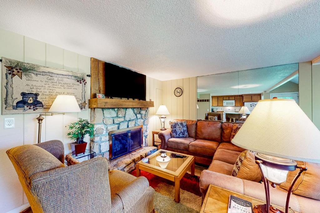 a living room with a couch and a fireplace at Hemlock Nob B11 in Sugar Mountain