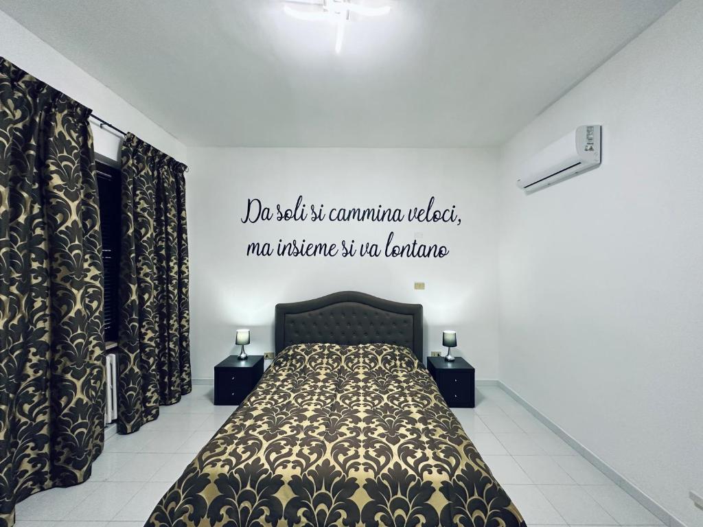 a bedroom with a bed with a poster on the wall at Siliade Apartment in Montesilvano