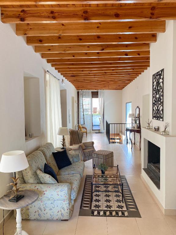 a living room with a couch and a fireplace at Casa de pueblo con encanto para desconectar in Terque