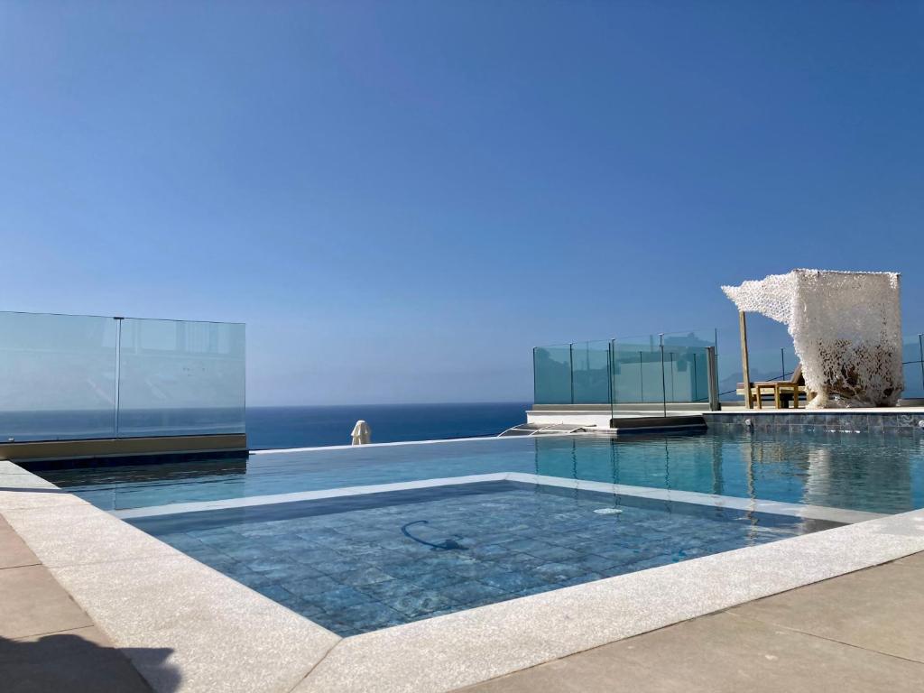 a swimming pool with the ocean in the background at Zax sea view villas in Ierapetra