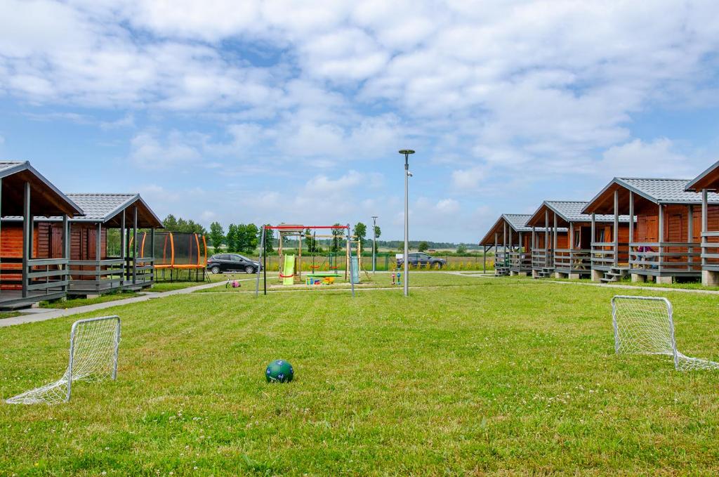 a soccer field with a soccer ball in the grass at Domki pod wzgórzem in Kopań