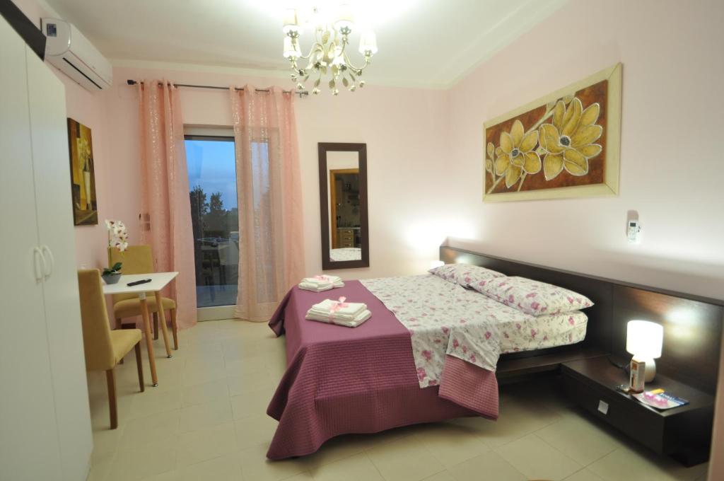 a bedroom with a bed and a table and a dining room at Boat dreams , garden relax in Matino