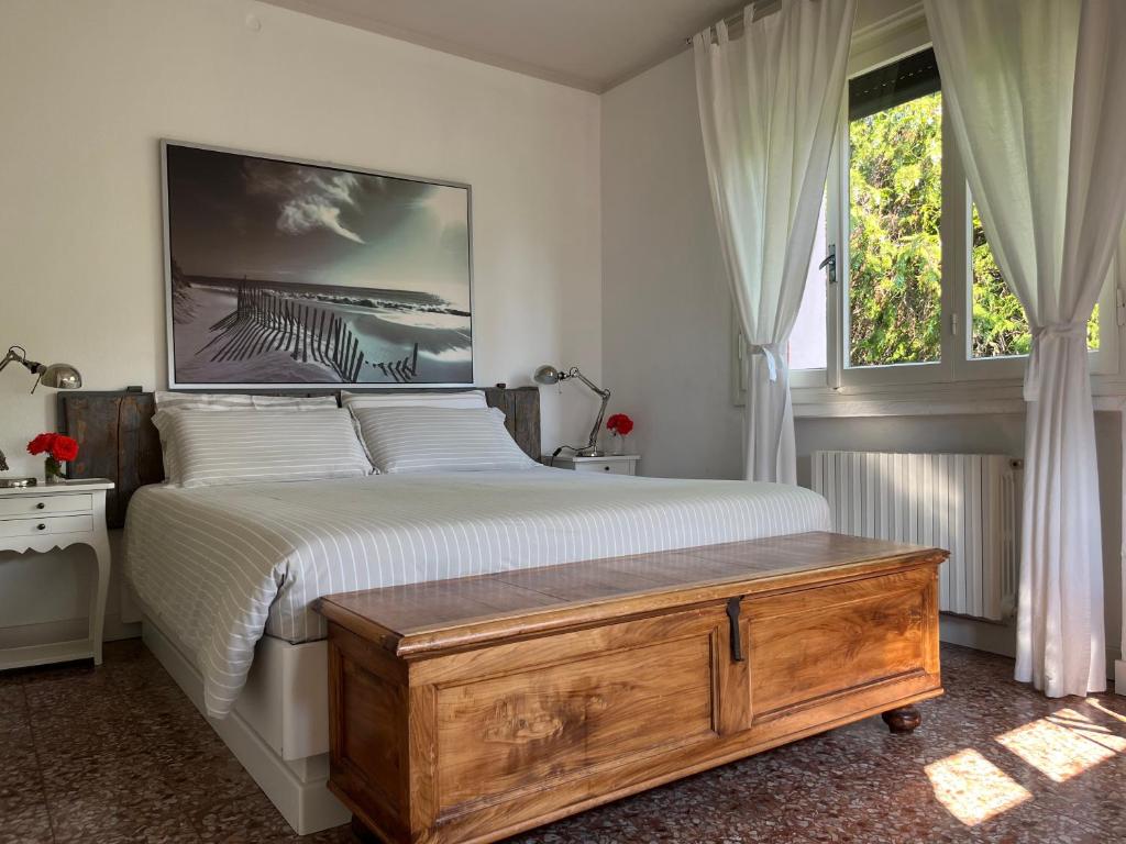 a bedroom with a large bed and a window at Le Vetrate sul Lago Lake Como Amazing View in Nesso
