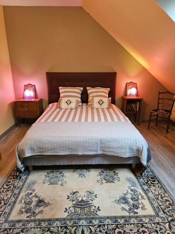 a bedroom with a large bed with two lamps at Comme à la maison in Monnaie