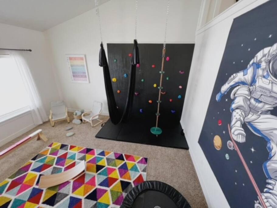 a kids room with a climbing wall and a play gym at Stunning 5 Bedroom Rexburg Home in Rexburg