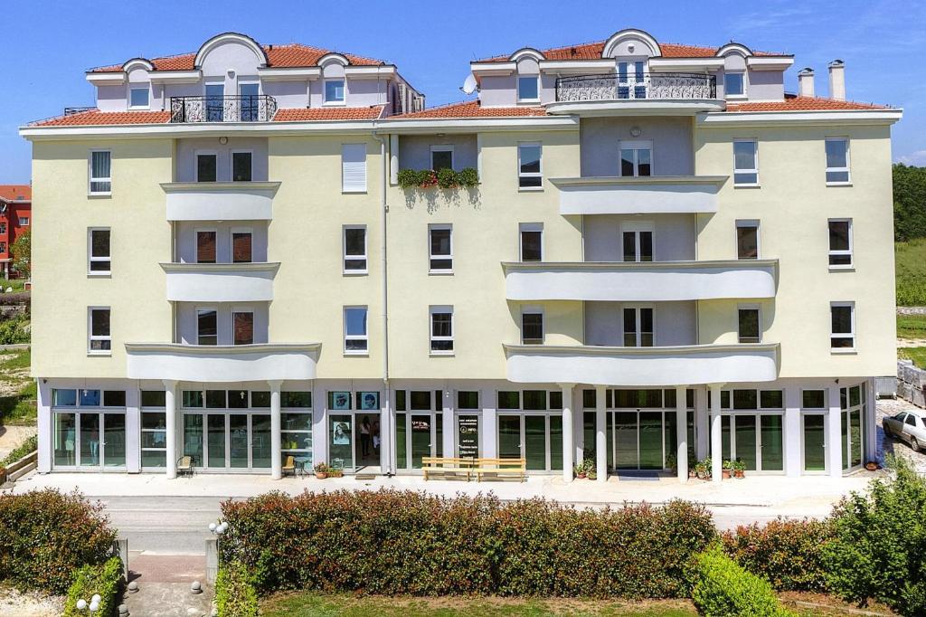 a large white building with a lot of windows at Hotel Leonardo in Međugorje