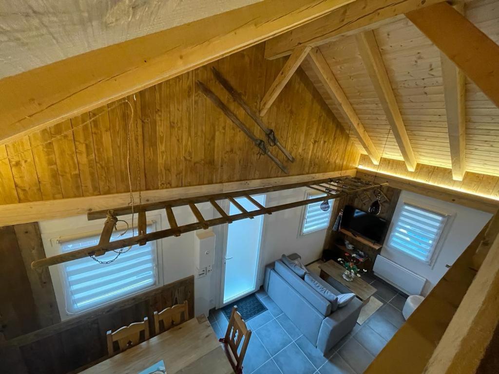 an overhead view of a living room with wood ceilings at La cabane de dany in La Bresse