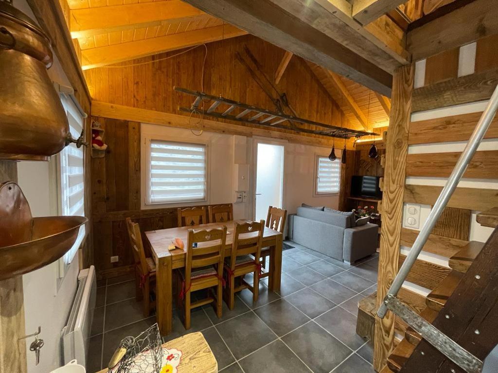 a kitchen and dining room with a table and chairs at La cabane de dany in La Bresse