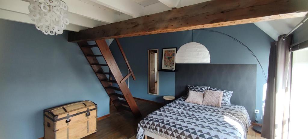 a bedroom with a bunk bed and a staircase at MAISON DE VACANCES aU 91 in Ardres
