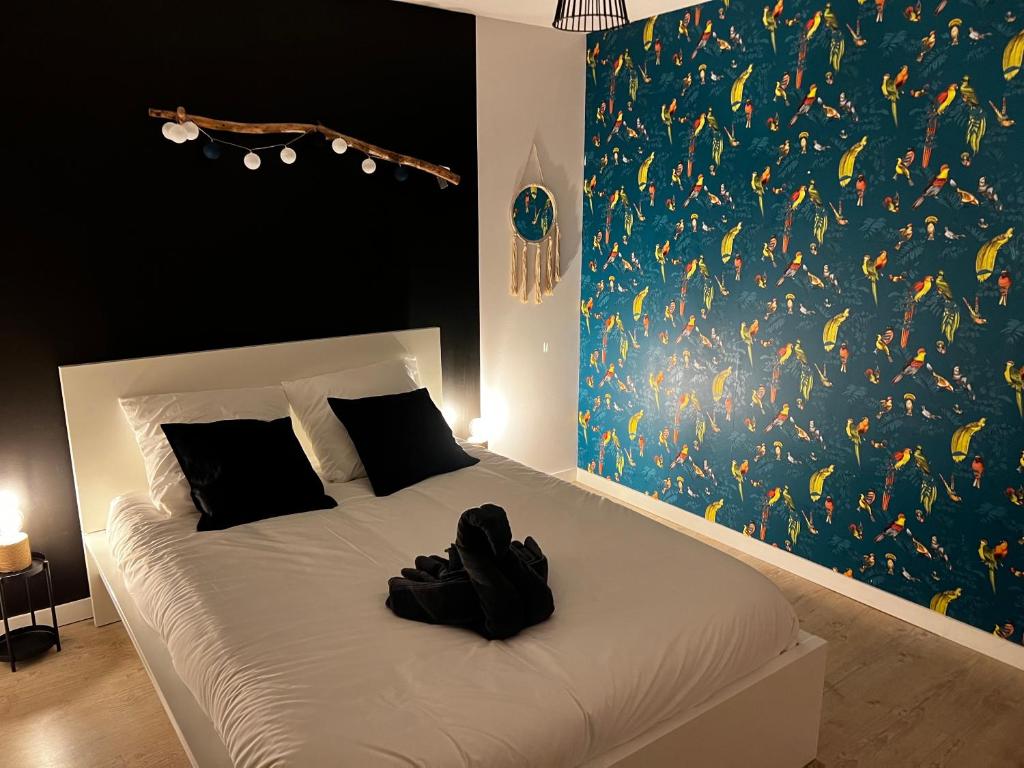 a bedroom with a bed with a large painting of fishes at Maison familiale 4 chambres avec jardin et piscine in Saint-Aignan-Grand-Lieu