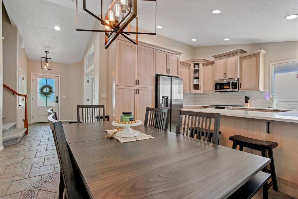 a kitchen with a wooden table and a dining room at The Lucky 7 - Family Home in Quiet Meridian in Meridian