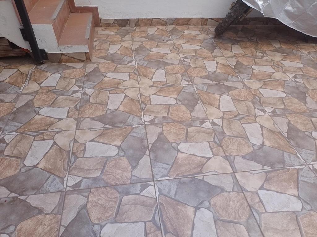 a stone floor in a room with a tile floor at Independent apartment Madonna in Cusco