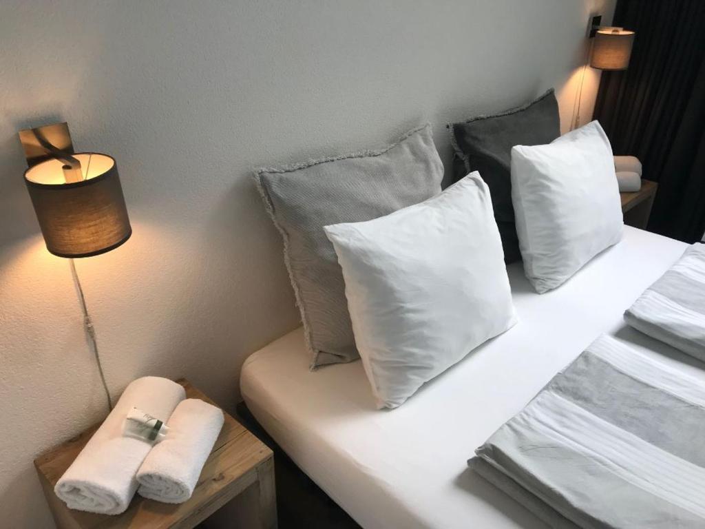een kamer met een bed met kussens erop bij Villa Yburg in Amsterdam