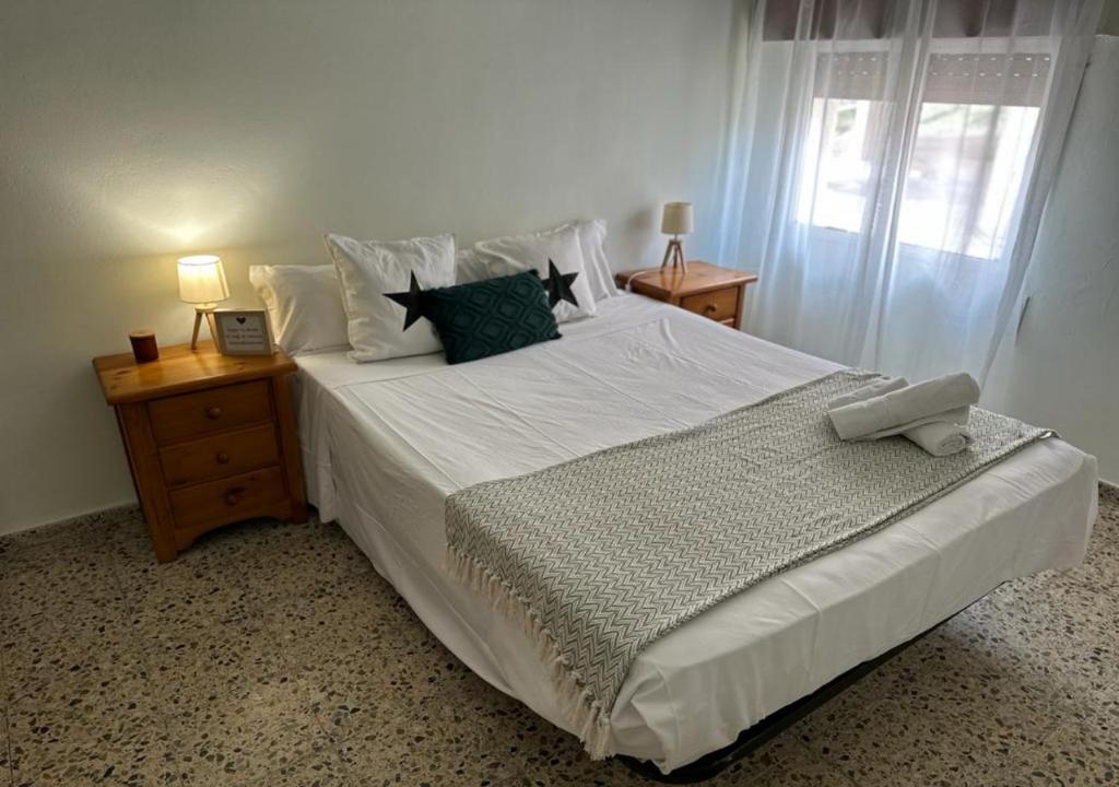 En eller flere senge i et værelse på Atico Alma