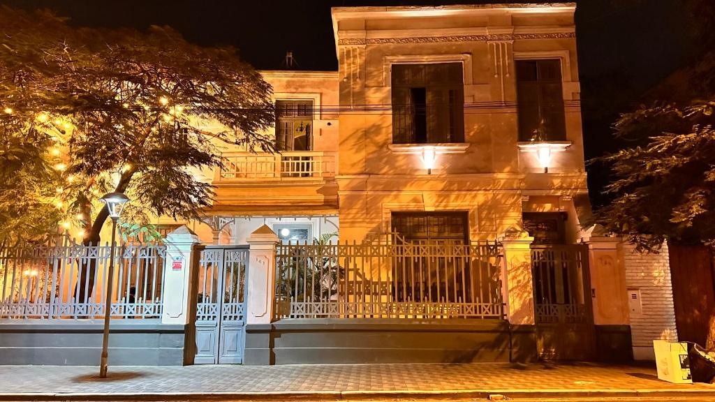 a building with a white fence in front of it at Ancestral Hostel Barranco in Lima