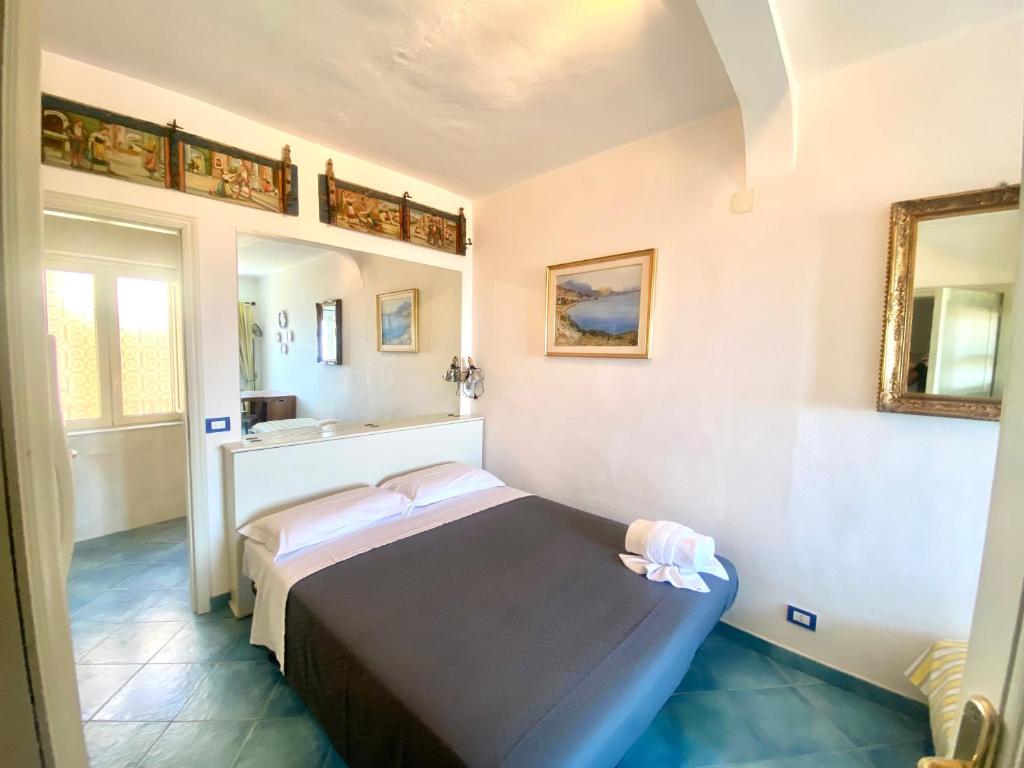 a room with a bed and a sink in it at Casa Ignazia in Taormina