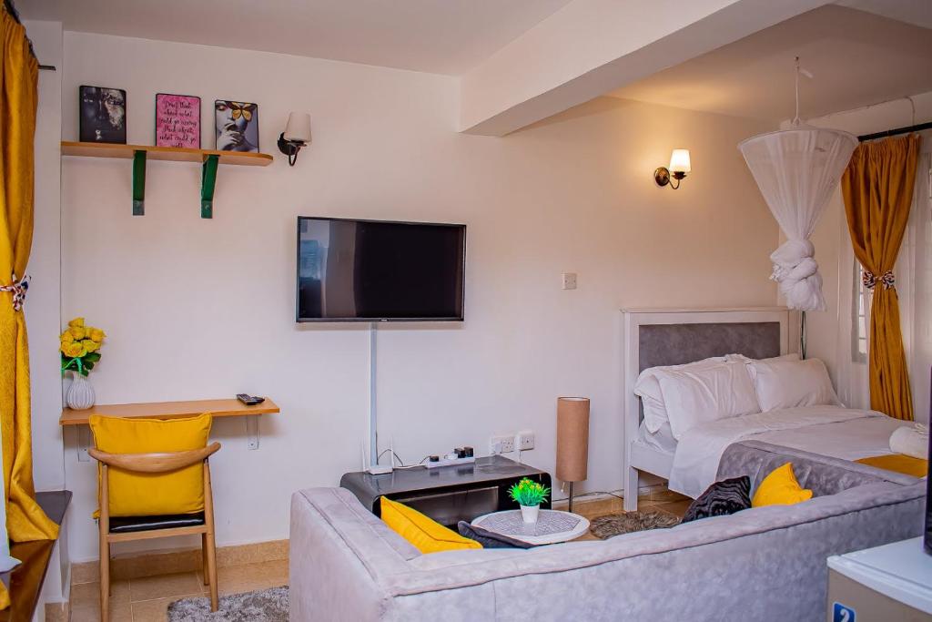 TV a/nebo společenská místnost v ubytování Belaire BnB Ruaka 1