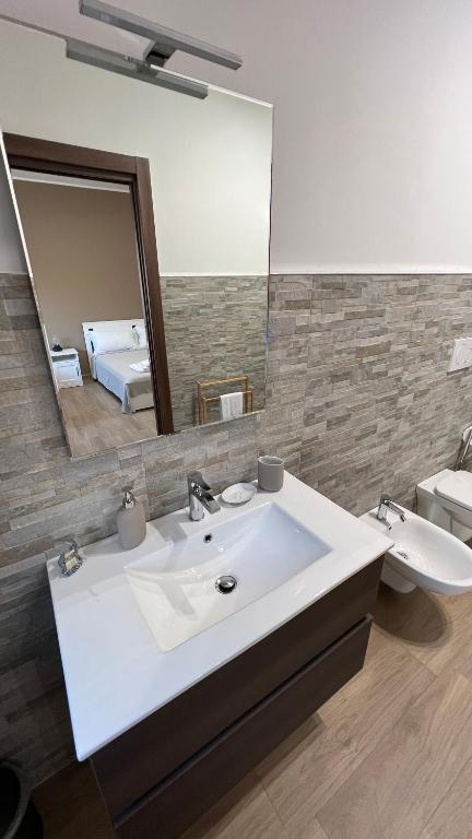 a bathroom with a white sink and a mirror at Cala Portavecchia in Monopoli