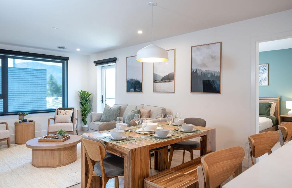 a dining room and living room with a table and chairs at Stoked On Revy - Family Condo in Revelstoke in Revelstoke