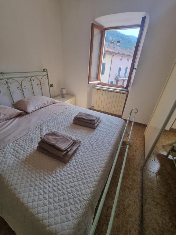 a bedroom with a bed with two towels on it at Il Borgo Apartment in Pignone