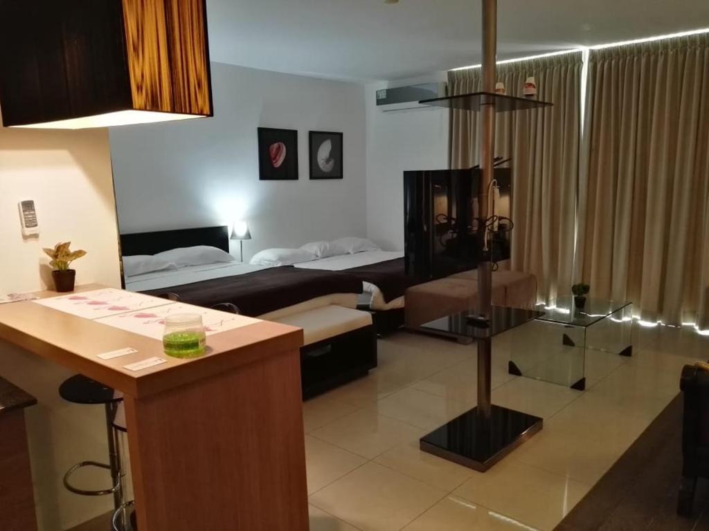 a living room with a room with a bed and a kitchen at Playa Blanca Panama in Río Hato
