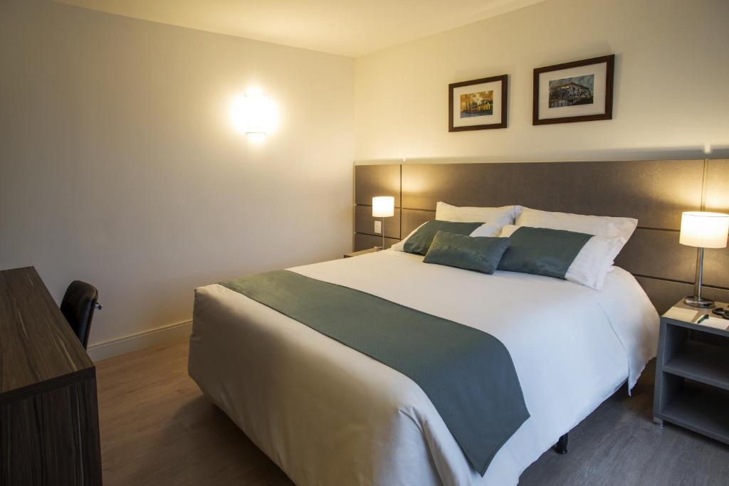 Postel nebo postele na pokoji v ubytování Hotel Laghetto Moinhos