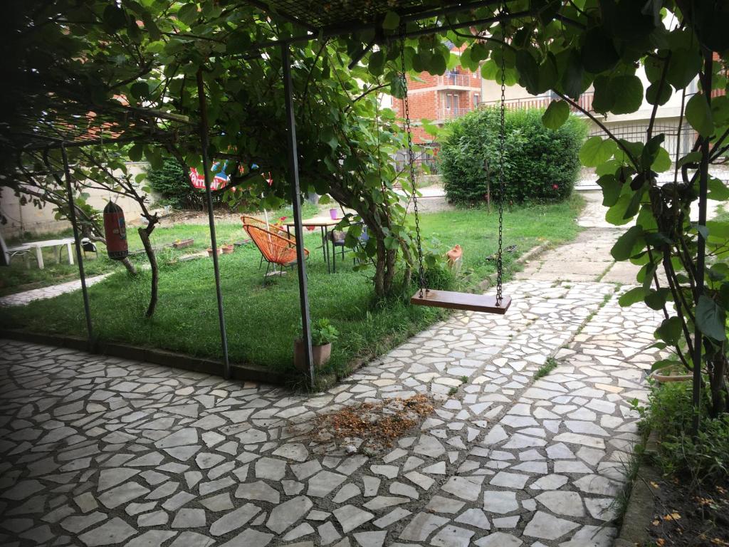 a garden with a swing and a yard with grass at Apartman Struga in Struga