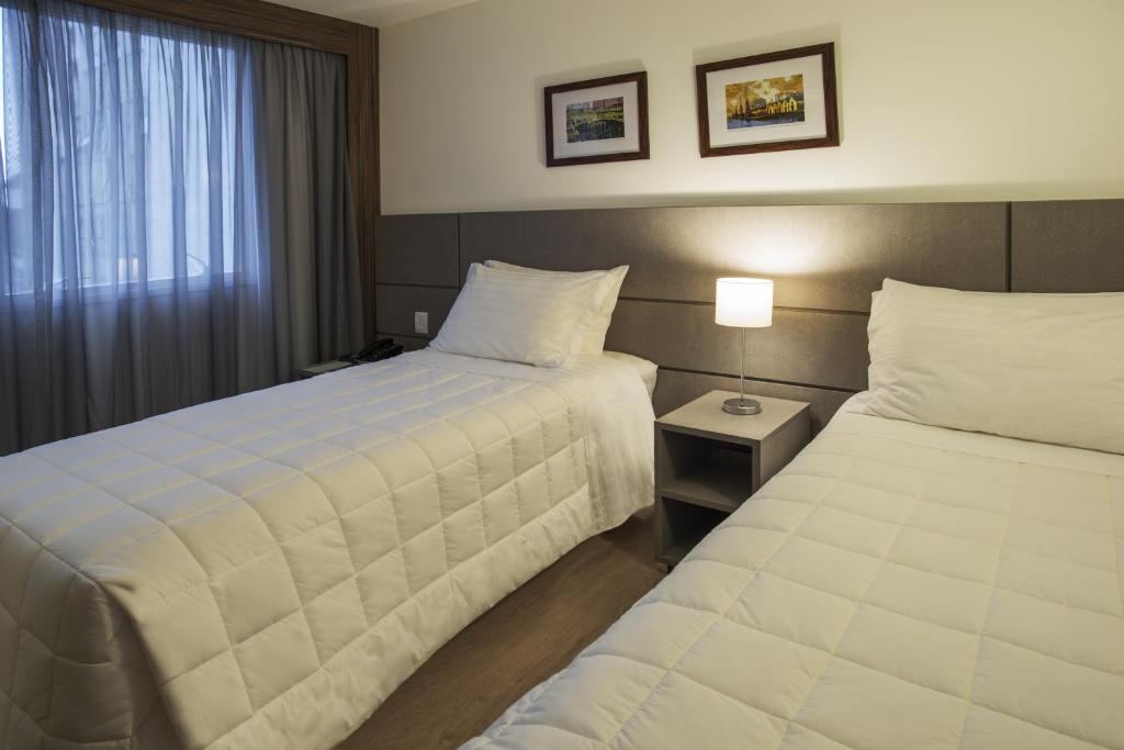 Postel nebo postele na pokoji v ubytování Hotel Laghetto Moinhos
