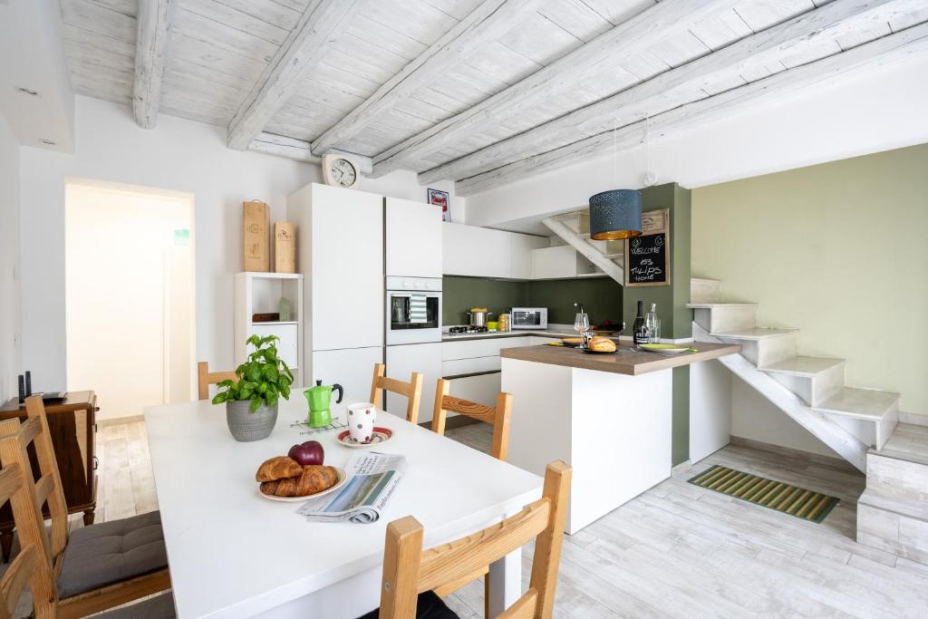cocina y comedor con mesa blanca y sillas en 153 Tulips Home, en Favaro Veneto