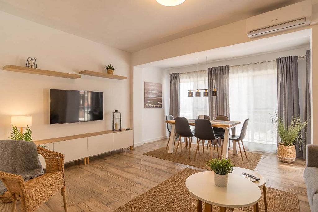 a living room with a table and a dining room at Modern brand new Apartment Torrevieja Centre 2 in Torrevieja