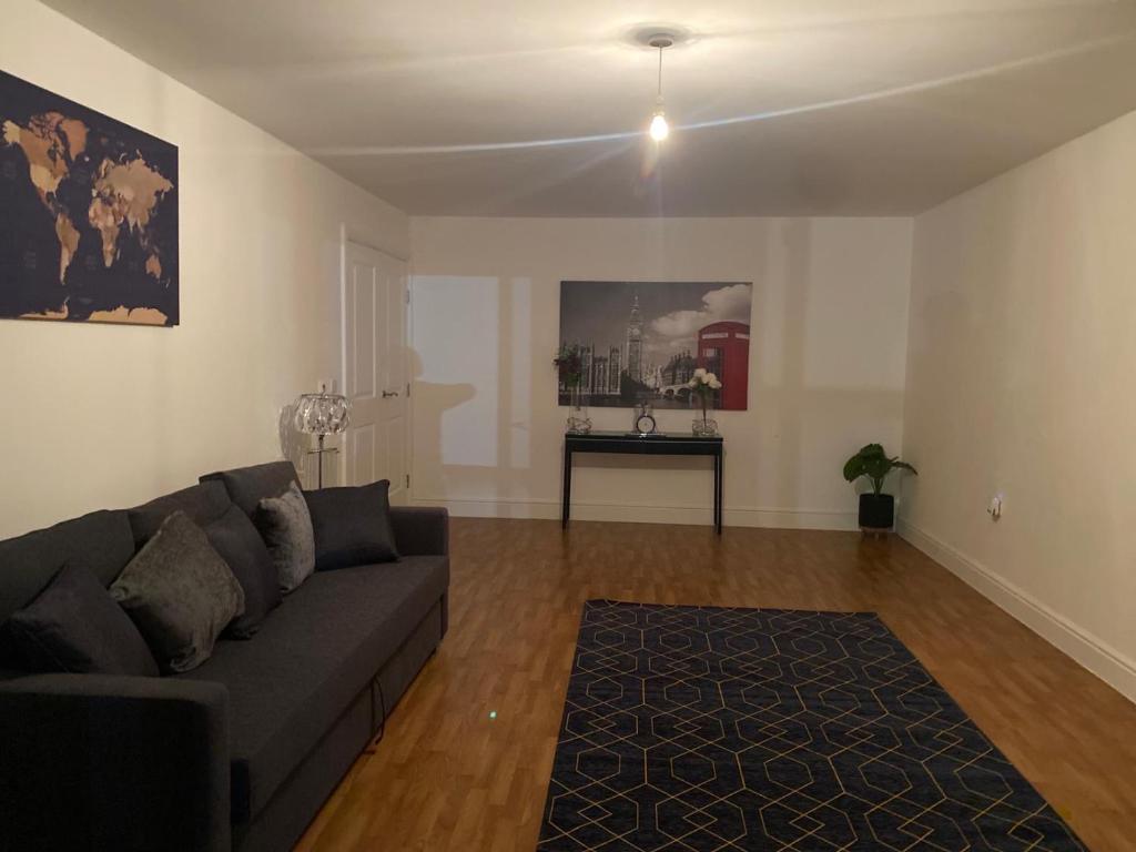 a living room with a couch and a table at Streatham high street in London