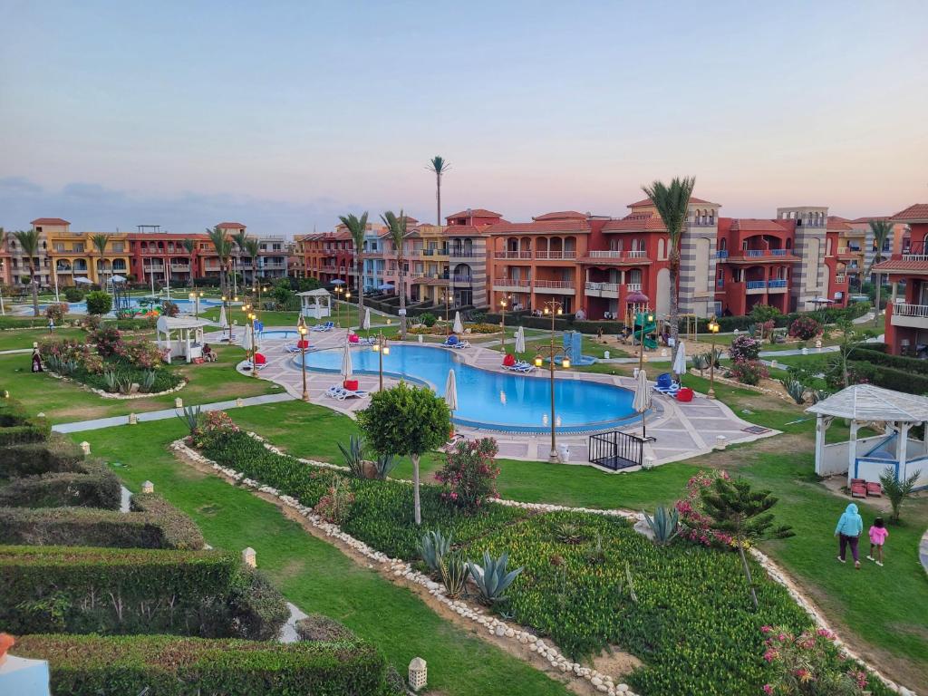 a resort with a swimming pool and some apartments at Porto Matrouh for FAMILIES ONLY in Marsa Matruh