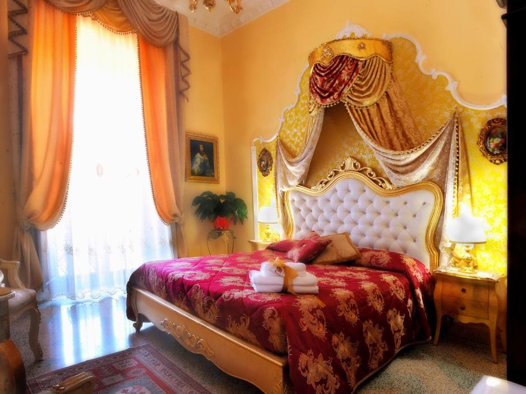 a bedroom with a king sized bed with a headboard at La Dolce Vita - Luxury House in Agrigento