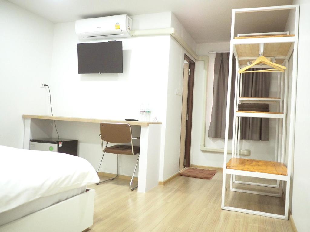 Postel nebo postele na pokoji v ubytování PD Apartment Inn