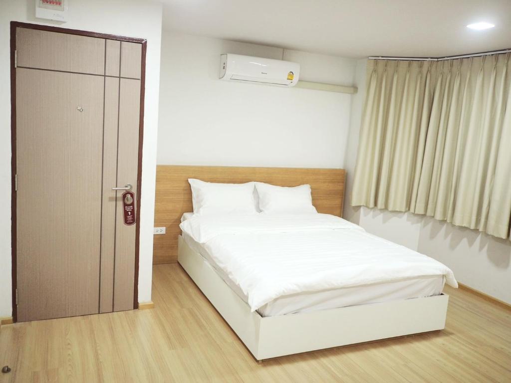 Postel nebo postele na pokoji v ubytování PD Apartment Inn