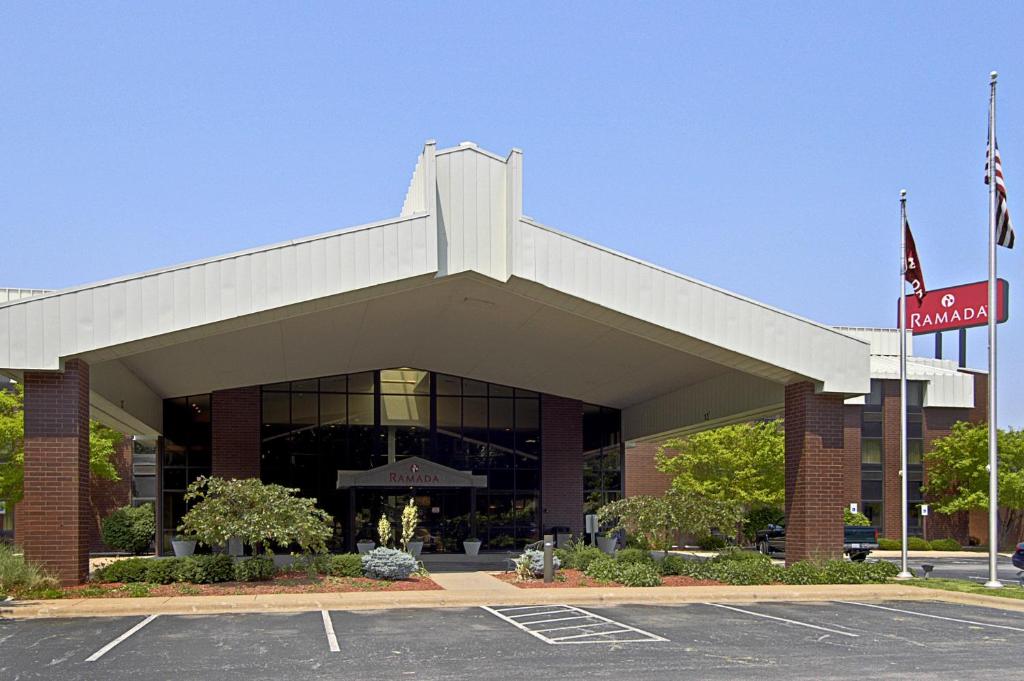 a parking lot in front of a building at Ramada by Wyndham Bettendorf in Bettendorf