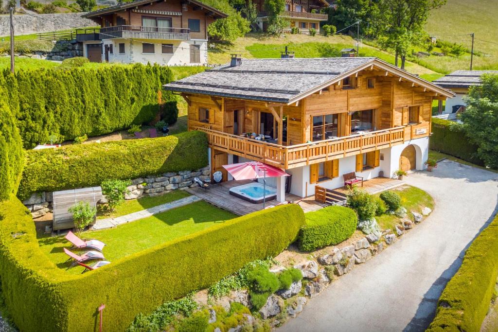an overhead view of a wooden house with a garden at Chalet Alyssum - OVO Network in Le Grand-Bornand