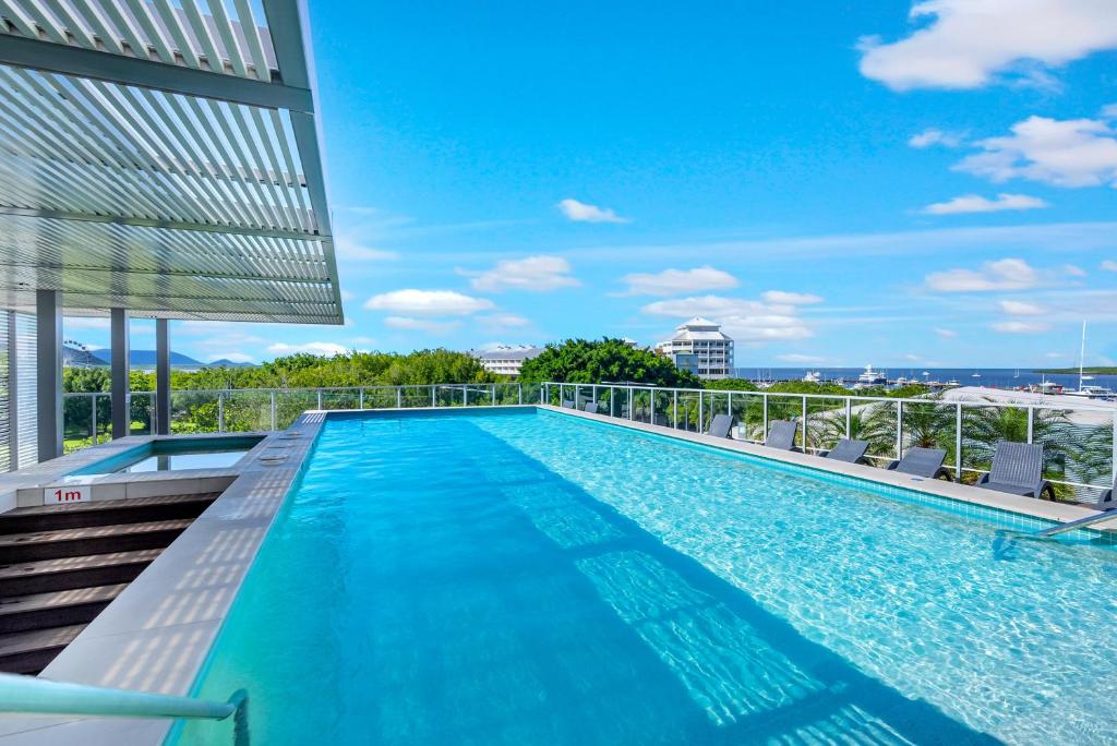 a swimming pool on the roof of a building at City Living at Harbour Lights in Cairns