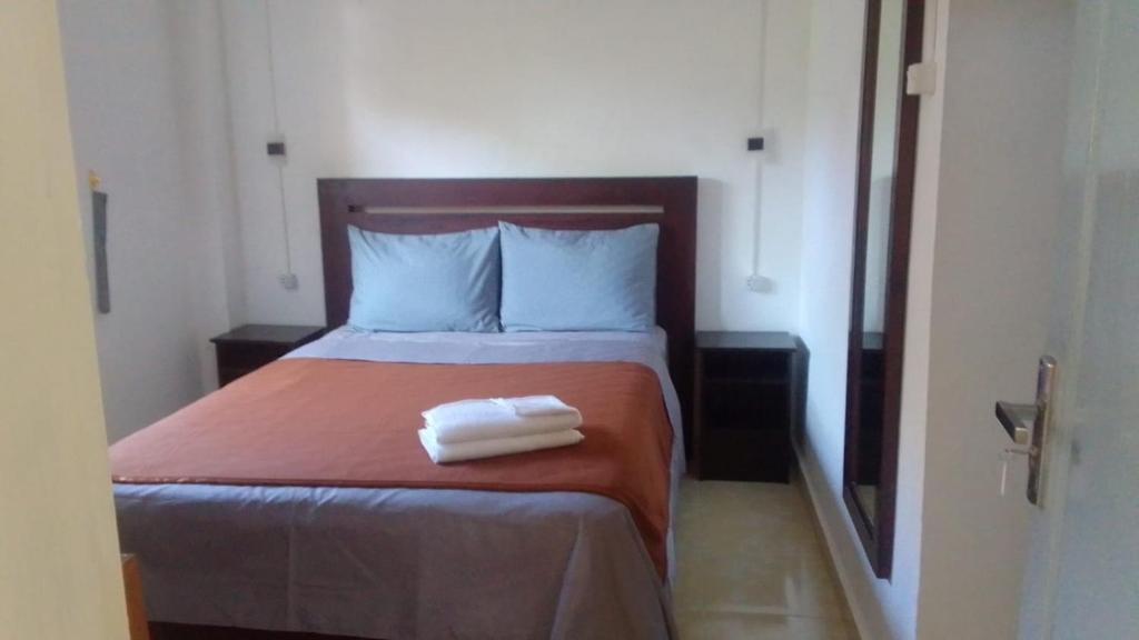 a bedroom with a bed with two towels on it at Hotel Arda Bali in Negara