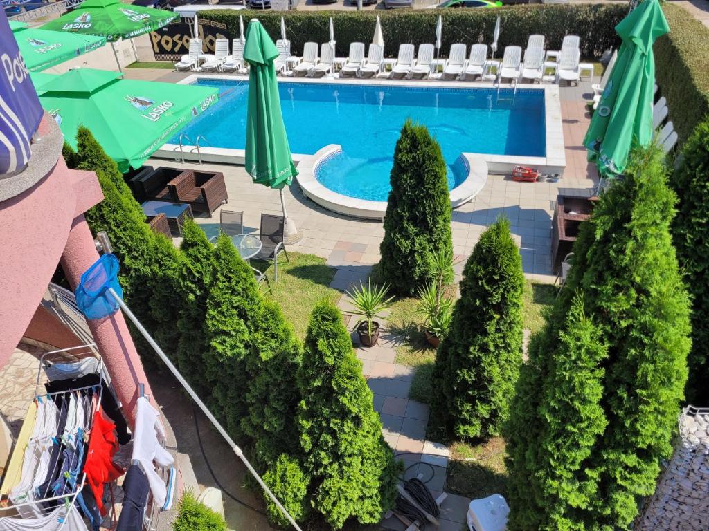 an overhead view of a pool with trees and umbrellas at Poseidon Apartment - Pool Access & Free Parking in Niš