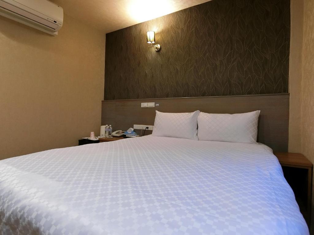 Postel nebo postele na pokoji v ubytování Taiwan Seven Days Boutique Hotel