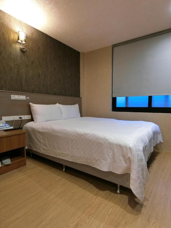 Postel nebo postele na pokoji v ubytování Taiwan Seven Days Boutique Hotel