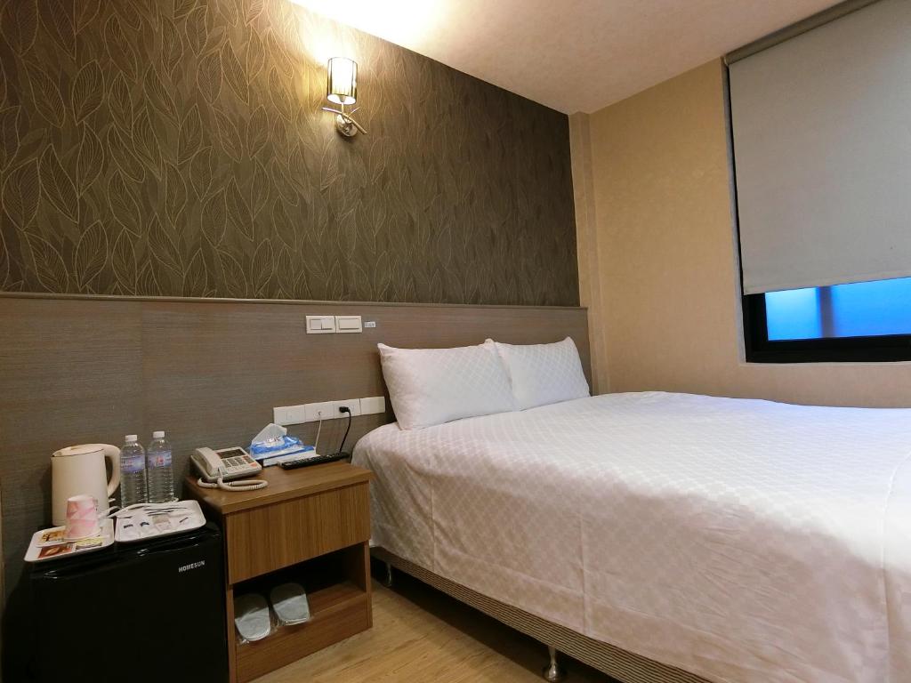 Postel nebo postele na pokoji v ubytování Taiwan Seven Days Boutique Hotel
