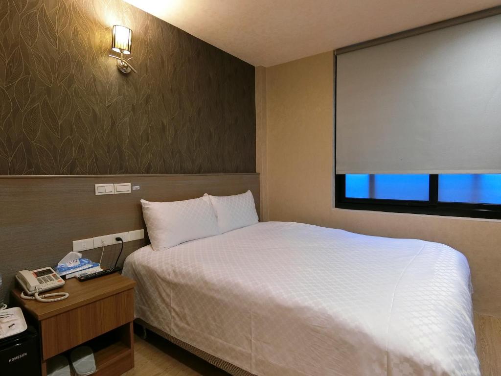 Postel nebo postele na pokoji v ubytování Taiwan Seven Days Boutique Hotel