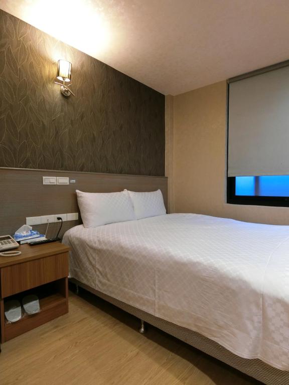 Postel nebo postele na pokoji v ubytování Taiwan Seven Days Boutique Hotel