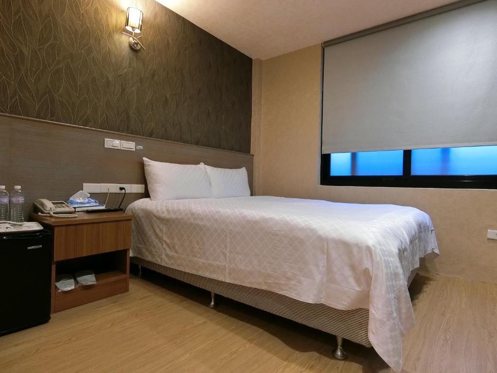 Postel nebo postele na pokoji v ubytování Taiwan Seven Days Boutique Hotel