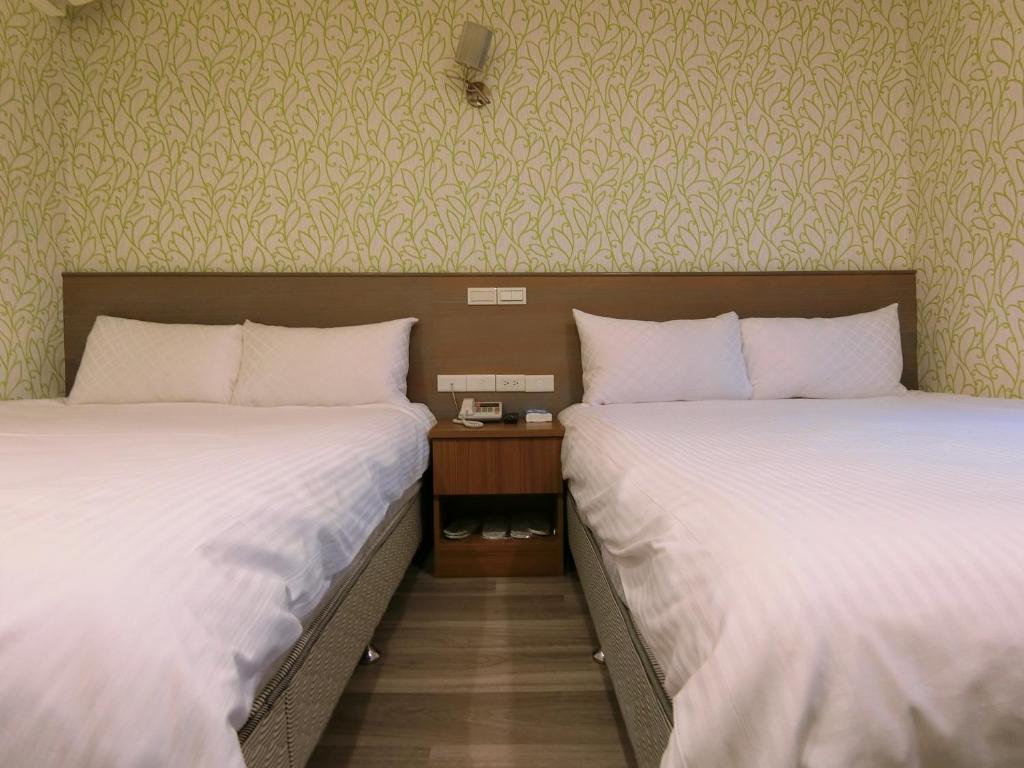 Postel nebo postele na pokoji v ubytování Taiwan Seven Days Boutique Hotel
